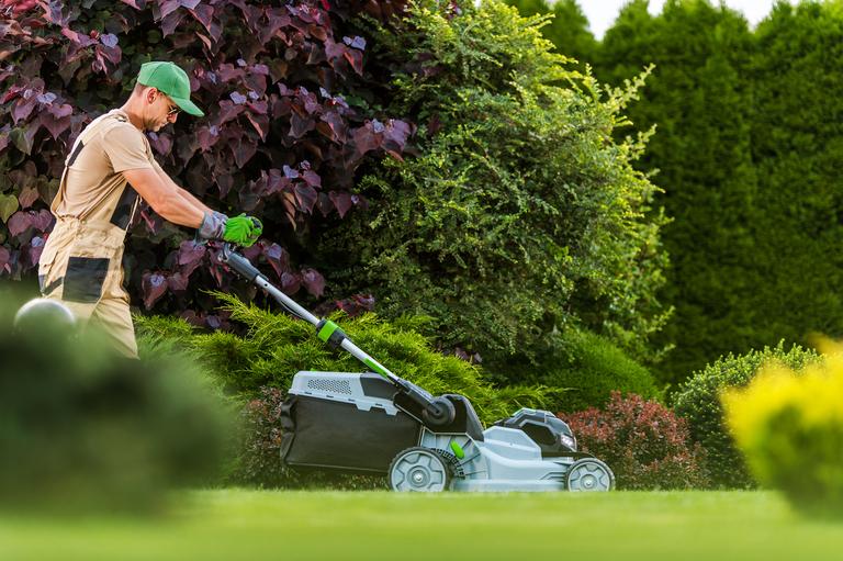 garden-worker-with-grass-mower-working-in-resident-2025-03-15-21-38-36-utc