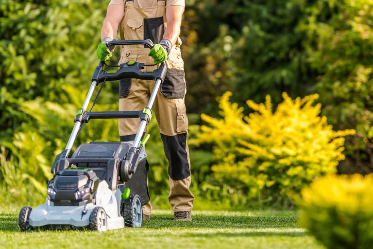 garden-worker-with-lawnmower-cutting-grass-2025-03-15-02-50-55-utc