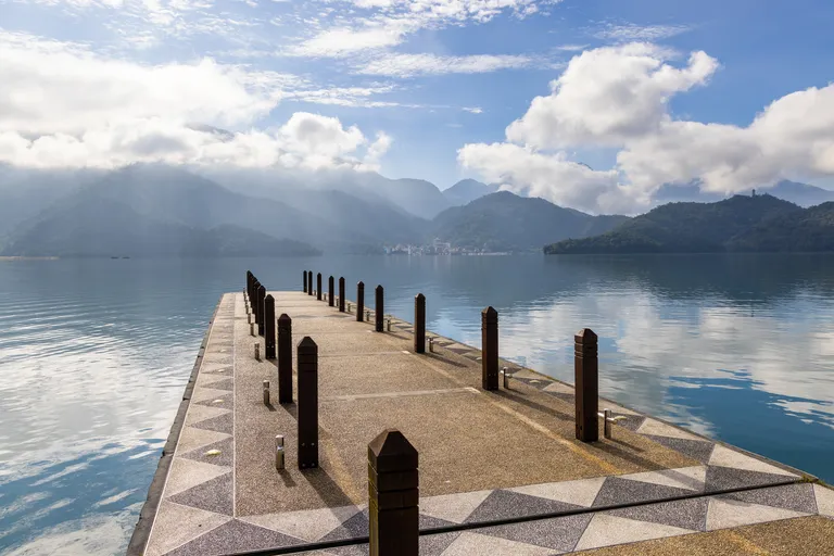 large-blue-lake-surrounded-by-mountains-with-pier-2025-03-25-17-19-40-utc